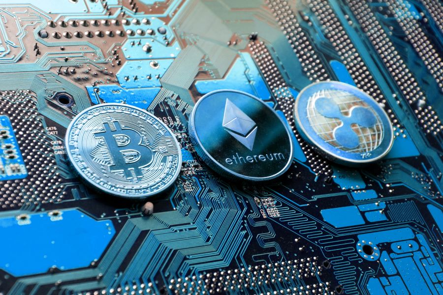 BTC, ETH, and XRP coins on top of motherboard