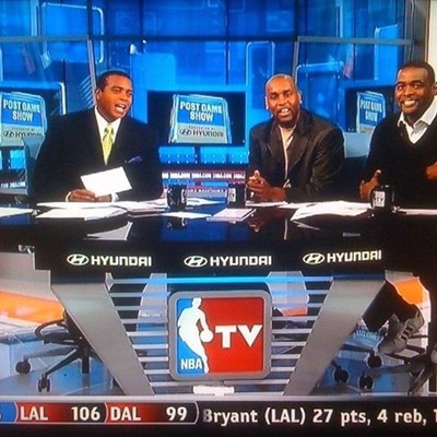 three men sitting at a news desk with the Hyundai logo on it on NBA TV