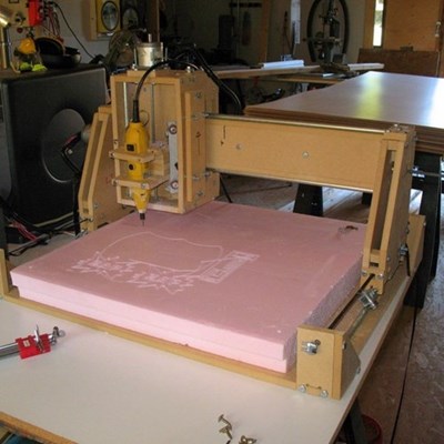 DIY CNC machine cutting a design in pink material