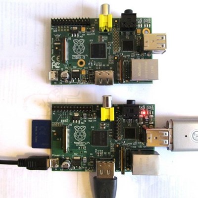 two Raspberry Pi tiny computers one with cables attached