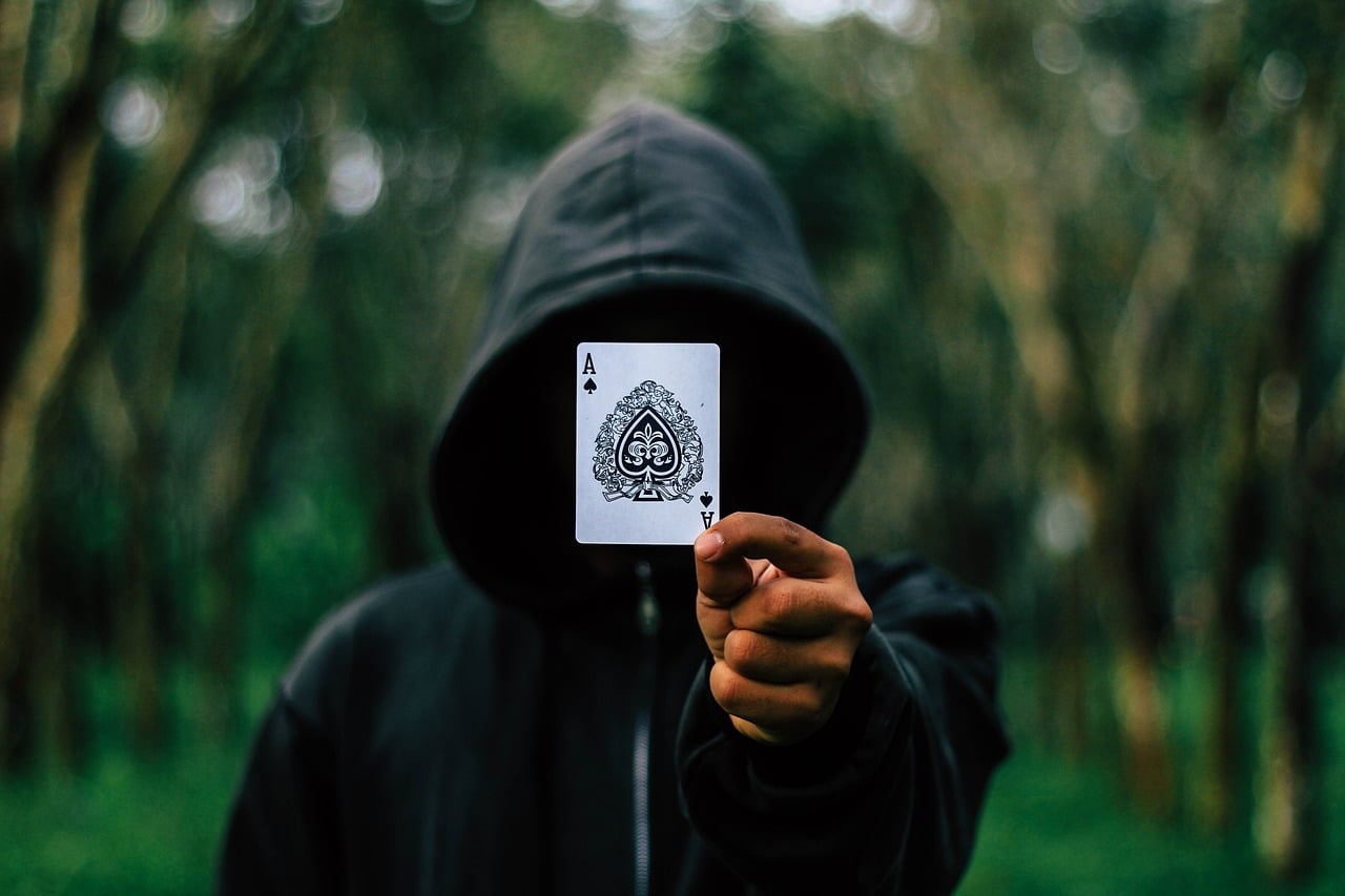 poker player showing ace card