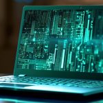 A laptop with code scrolling down the screen