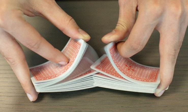 Poker dealer shuffling cards