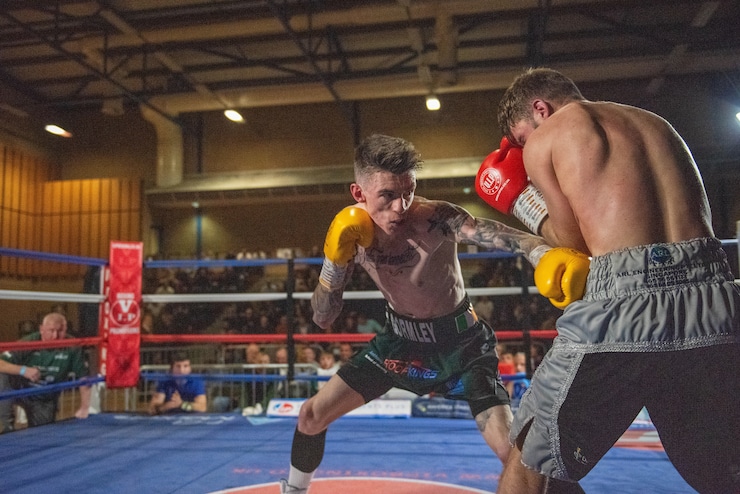 Lee Gormley and his opponent engage in a match in a ring.