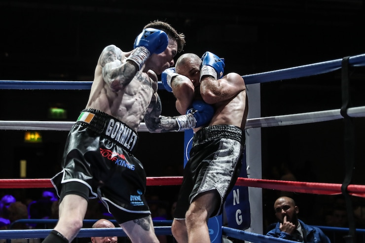 Lee Gormley delivers a powerful punch to an opponent an intense match in the ring.