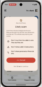 A smartphone displays a warning about a likely scam call, advising the user to end the call and not share personal information.