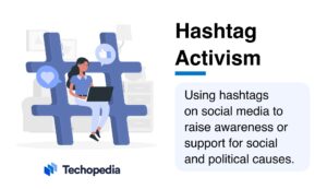 A person using a laptop sits beside a large hashtag symbol, illustrating the concept of hashtag activism for social and political causes.