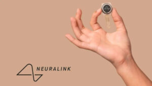 A hand holds a Neuralink device with delicate wires, set against a beige background. The Neuralink logo is on the left, conveying innovation and technology.